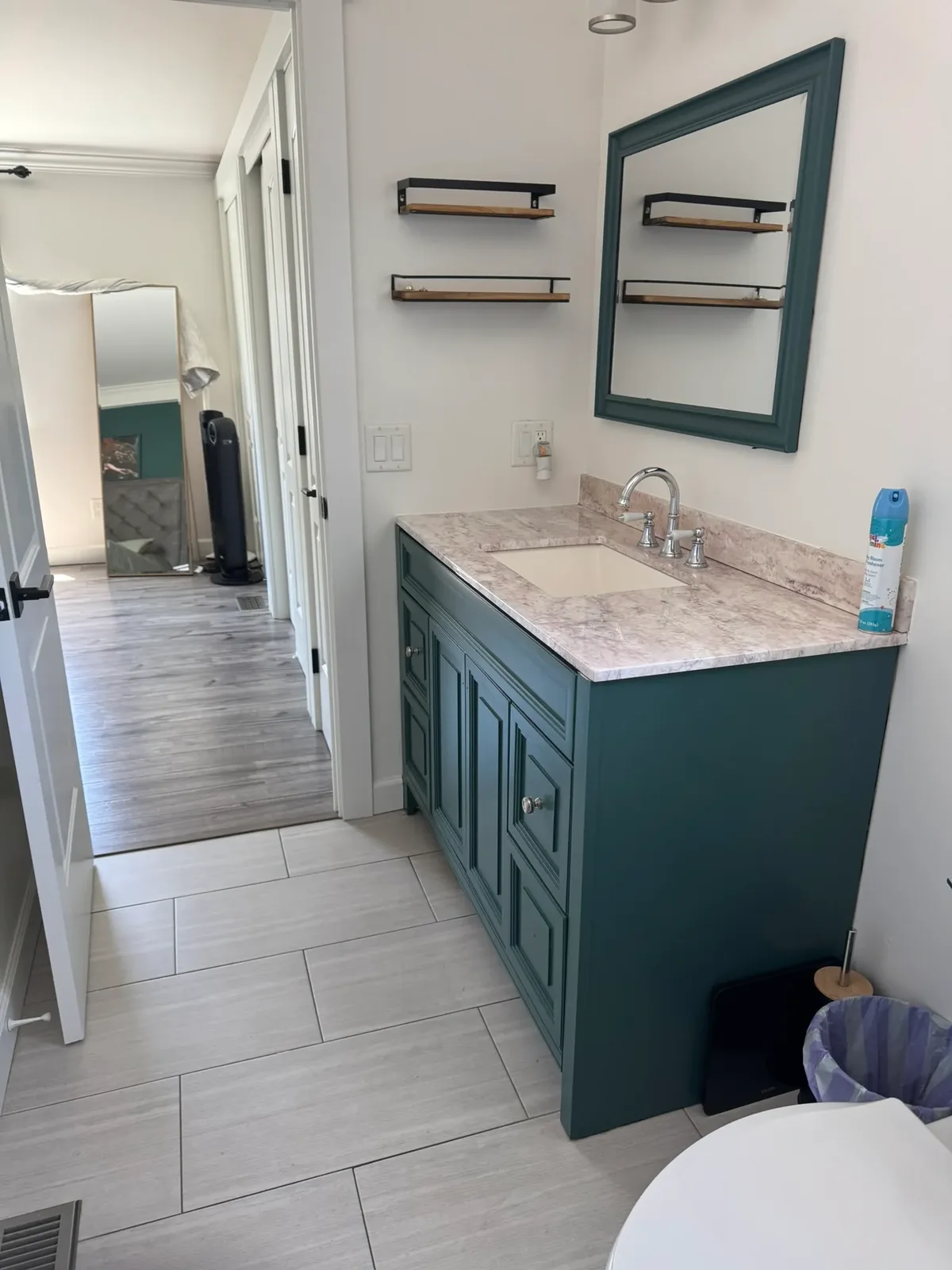 Detailed clean of a teal bathroom vanity with marble top