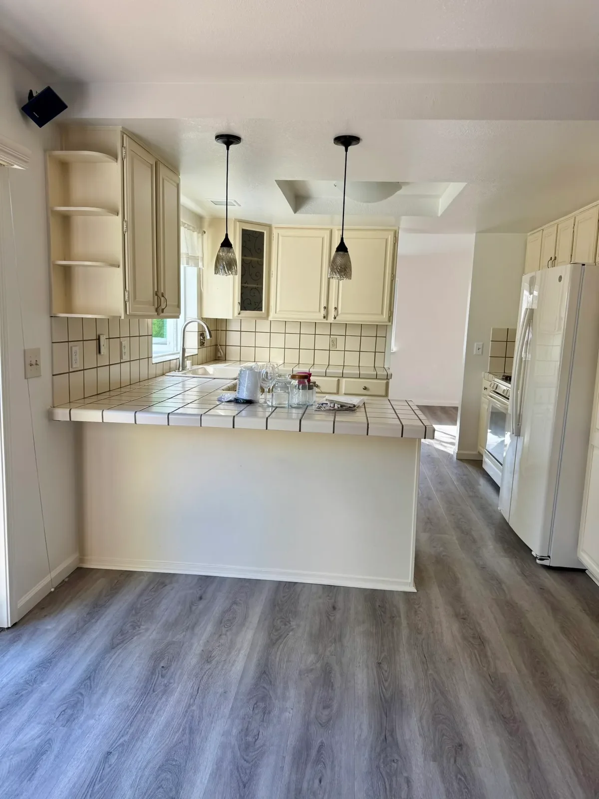 Bright cream kitchen with tile counters, cleaned