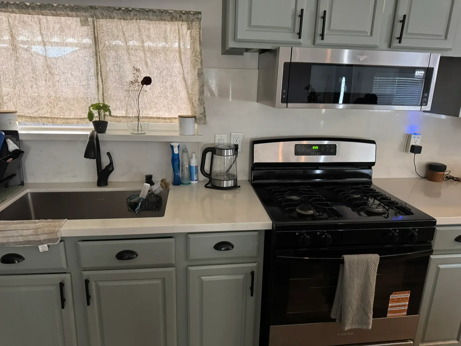 Sage-green kitchen with gas range, cleaned