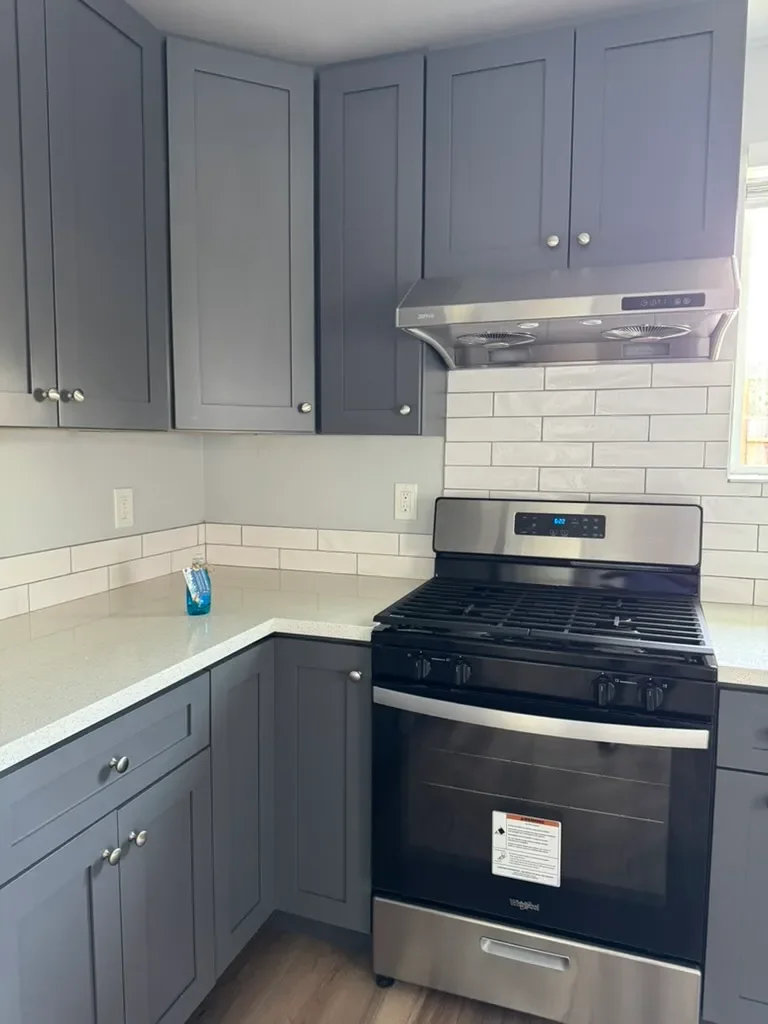 Gray kitchen with stainless range and subway tile after cleaning